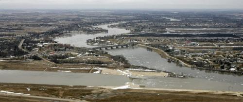 MIKE.DEAL@FREEPRESS.MB.CA 110408 - Friday, April 08, 2011 - The Red River flyover north of Winnipeg during the 2011 Flood. The floodway gates on the Red River (right) and the water from the floodway meet (bottom left). MIKE DEAL / WINNIPEG FREE PRESS