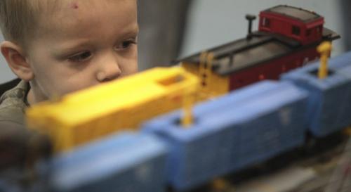 MIKE.DEAL@FREEPRESS.MB.CA 110409 - Saturday, April 09, 2011 - The Winnipeg Model Railroad Club spring show was at Westworth United Church on Saturday. Ethan Manuel, 2, gets in close to check out the cars as they roll past. MIKE DEAL / WINNIPEG FREE PRESS