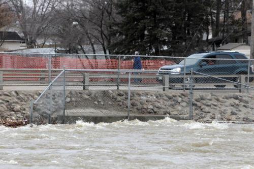 MIKE.DEAL@FREEPRESS.MB.CA 110409 - Saturday, April 09, 2011 - Water from Sturgeon Creek rushes under Ness Ave. Saturday afternoon. MIKE DEAL / WINNIPEG FREE PRESS