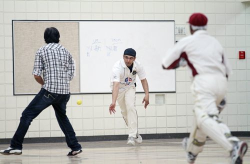 Brandon Sun 09042011 Tanvir Khundkar of the Brandon Cricket Club throws the ball at the wicket during the BCC's match against the Taverners Cricket Club in the fifth annual Western Manitoba Indoor Cricket Tournament at the Kirkcaldy Heights School gymnasium on Saturday.  (Tim Smith/Brandon Sun)