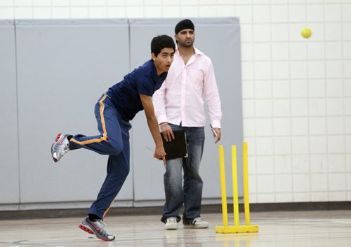 Brandon Sun 09042011 Akash Patel of the Brandon Cricket Club throws a pitch during the BCC's match against the Taverners Cricket Club in the fifth annual Western Manitoba Indoor Cricket Tournament at the Kirkcaldy Heights School gymnasium on Saturday.  (Tim Smith/Brandon Sun)