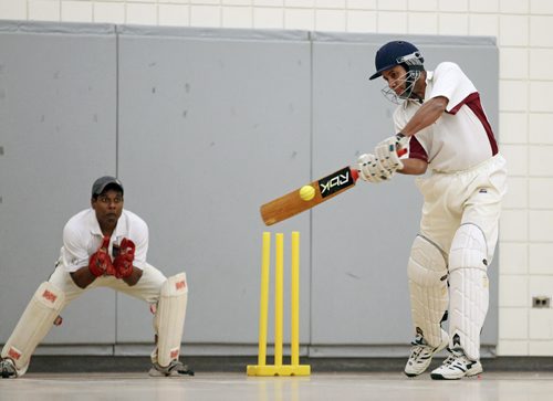 Brandon Sun 09042011 Chomo Vanderwert of the Taverners Cricket Club connects with the ball during the Taverners match against the Brandon Cricket Club in the fifth annual Western Manitoba Indoor Cricket Tournament at the Kirkcaldy Heights School gymnasium on Saturday.  (Tim Smith/Brandon Sun)