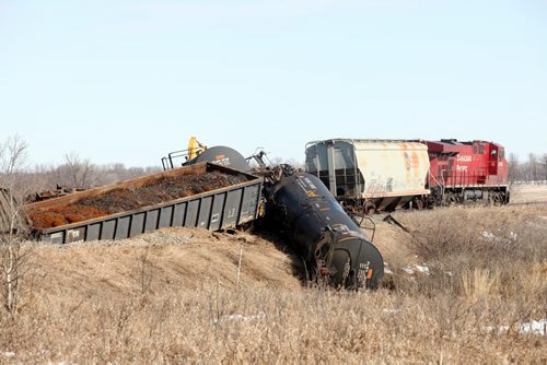 Brandon Sun 11042011 Cars from a Canadian Pacific train lie strewn across the tracks northeast of Hartney, Man. on Monday morning after a derailment Sunday evening. No one was injured in the derailment which involved several train cars. (Tim Smith/Brandon Sun)