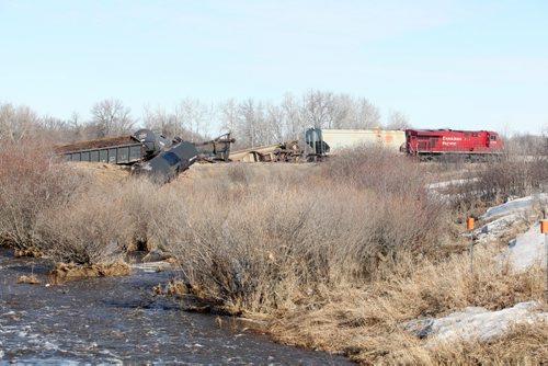 Brandon Sun 11042011 Cars from a Canadian Pacific train lie strewn across the tracks northeast of Hartney, Man. on Monday morning after a derailment Sunday evening. No one was injured in the derailment which involved several train cars. (Tim Smith/Brandon Sun)