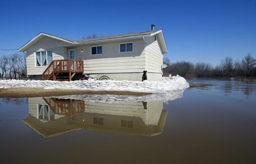 WAYNE.GLOWACKI@FREEPRESS.MB.CA The home of Richard Spence is dry and is protected by a sandbag dike on the Peguis First Nation Community after flooding from the Fisher River. Melissa Martin story Winnipeg Free Press April 14  2011