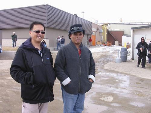 Olivan Afuang (wearing sunglasses over his eyes) and Efren Macatangay are Filipino immigrants to Neepawa, in front of the HyLife hog plant. Efren works in the plant and Olivan is a registered nurse.  Olivan Afuang is on the left, Efren Macatangay on the right. bill redekop / winnipeg free press