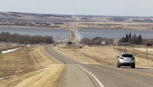 Brandon Sun Flood waters from the Assiniboine River line either side of Highway 21 through Sioux Valley Dakota Nation on Wednesday afternoon.  (Bruce Bumstead/Brandon Sun)