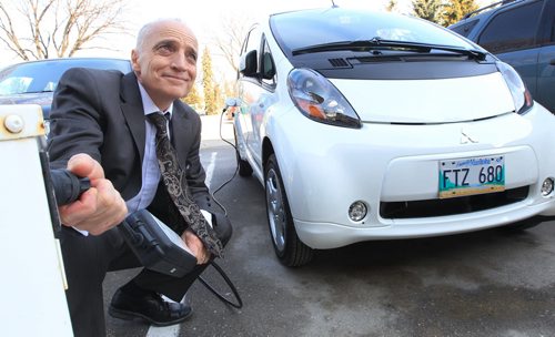 JOE.BRYKSA@FREEPRESS.MB.CA   Local- ( See Owen story)-   Energy and Mines Minister Dave Chomiak unplugs a i-MiEV Mishubishi electric car in his parking stall in front of the Manitoba Legislature Thursday afternoon-  On the eve of Earth day the Manitoba government signed a memorandum of understanding with Mitshubishi Canada to use Manitoba as a testing ground to further develop and test their electric cars. - JOE BRYKSA/WINNIPEG FREE PRESS- Apr 21, 2011