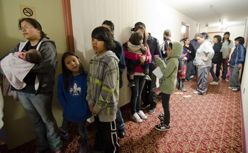 DAVID LIPNOWSKI / WINNIPEG FREE PRESS (April 24, 2011) Roseau River First Nation evacuees wait in line to register for rooms at The Marlborough Hotel Sunday afternoon.