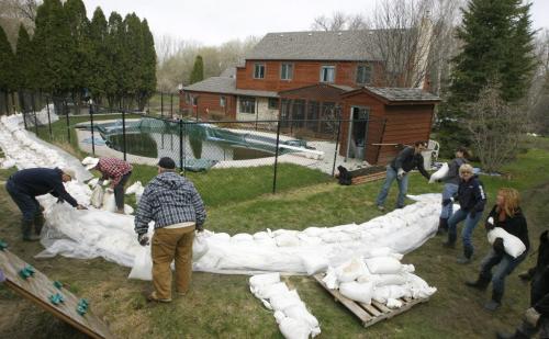MIKE.DEAL@FREEPRESS.MB.CA 110511 - Wednesday, May 11, 2011 -  Flood fight is on in St. Francois Xavier at Tracy and Greg Didyk's place. They have a ring dike that they were told to raise by flood forcasters last night. Around 30 friends and family showed up on short notice to help.  MIKE DEAL / WINNIPEG FREE PRESS