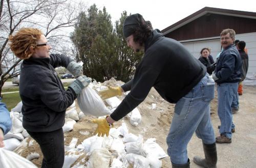 MIKE.DEAL@FREEPRESS.MB.CA 110511 - Wednesday, May 11, 2011 -  Homeowner Leslie Howard (left) lives at the corner of HWY 248 and Bernardin Street in the heart of Elie, MB. Most homeowners were sandbagging their homes today fearing that the water from the cut in the Assiniboine River would flood out the town. MIKE DEAL / WINNIPEG FREE PRESS