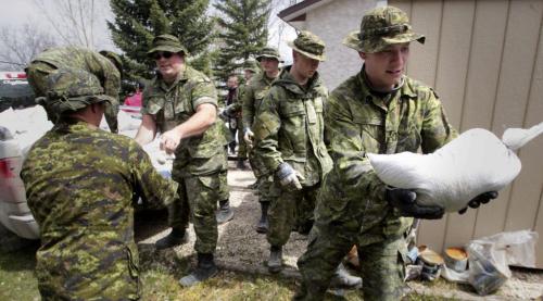 MIKE.DEAL@FREEPRESS.MB.CA 110511 - Wednesday, May 11, 2011 -  Members of the reserve based out of the Minto Armoury help sandbag homes in Elie, MB. Private Jason MacFarlane on the right. MIKE DEAL / WINNIPEG FREE PRESS
