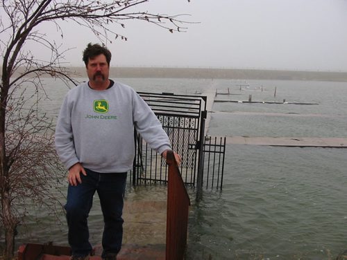 Lake Manitoba waters have begun encroaching on Blair Olafson as he inspects his flooded docks at Narrows West Lodge. Olafson is also a cattle farmer. Bill Redkop story/photo. Winnipeg Free Press. May 11 2011.