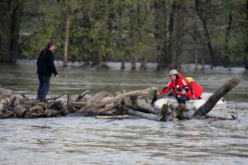 Winnipeg, Manitoba - May 14, 2011 - A man is rescued from a drift of logs at The Forks in Winnipeg Saturday, May 14, 2011. The two men were in a canoe which capsized on the Assiniboine River and emergency personnel are still looking for the other man who was carried further downstream. (John Woods/Winnipeg Free Press)
