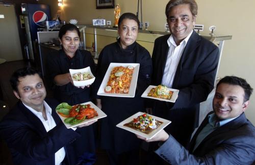 BORIS.MINKEVICH@FREEPRESS.MB.CA   BORIS MINKEVICH / WINNIPEG FREE PRESS 110518 Water Lily restaurant- l-r. Rashid Islam, Pinky Singh, Narmin Biswas, Rana Biswas, and Antu Biswas, pose for a photo with some most wonderful dishes they serve at the east Indian restaurant across from St. Vital Centre.