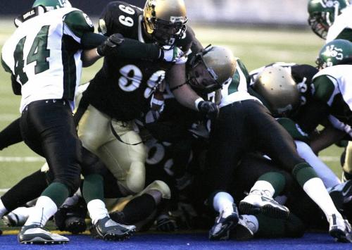 John Woods / Winnipeg Free Press / November 11, 2006 - 061111 - With the help of Bisons Matt Harper (99) QB John  Makie (7) goes in for a TD in the first half of the west division finals Saturday Nov 11/06.