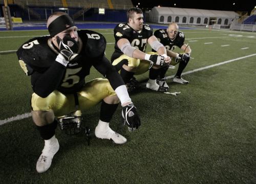John Woods / Winnipeg Free Press / November 11, 2006 - 061111  - Cory Huclak (5), Terry Watson (67) and Mike Howard (22) (LtoR)  hang their heads after being defeated by U of Sask. in the western final Saturday Nov 11/06.