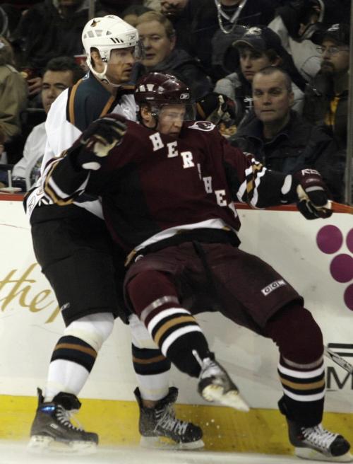 John Woods / Winnipeg Free Press / November 11, 2006 - 061111  - Moose Alexandre Bolduc (49) takes Bears Timo Helbling (32) off the puck in second period action Saturday Nov 11/06.