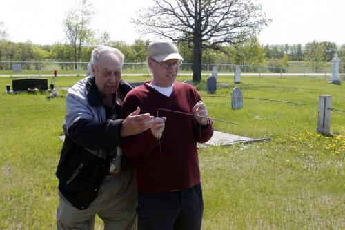 BORIS.MINKEVICH@FREEPRESS.MB.CA   BORIS MINKEVICH / WINNIPEG FREE PRESS 110525 Jack Mavins is a grave witcher. Here Bill shows his stuff at an old cemetery near Dugald, Manitoba.
