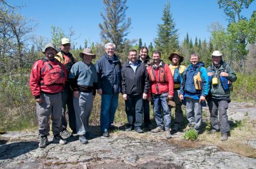 credit Pimachiowin Aki tour photographer J.J. Ali UNESCO bid tour on the Bloodvein River Manitoba Premier Greg Selinger and Aboriginal and Northern Affairs Minister Eric Robinson flanked by wilderness canoeists and others on shoreline where tour encountered the canoe crew. Paul Lawler is to the right of Robinson. for Alex Paul story in Winnipeg Free Press