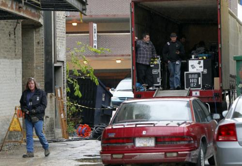 BORIS.MINKEVICH@FREEPRESS.MB.CA   BORIS MINKEVICH / WINNIPEG FREE PRESS 110527 U2 fans hang out in the rain behind the Burton Cummings Theatre in an effort to catch a glimpse of the Irish rock band. In this photo crewa behind the theatre unload gear.