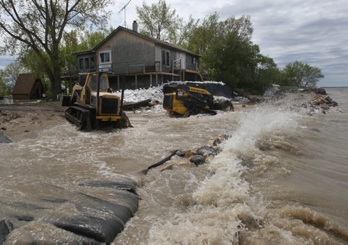 JOE.BRYKSA@FREEPRESS.MB.CA  Twin Lakes Beach- ( See   story)-  Heavy equipment works to make a breakwater in the front of two cottages  in Twin Lakes Beach Monday afternoon- Flooding from Lake Manitoba has given the local municipality a state of emergency so they can have access the cottages . Last week heavy winds caused flooding one road  that gives access to cottagers and full time residents-JOE BRYKSA/WINNIPEG FREE PRESS- May 30, 2011