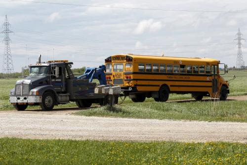 BORIS.MINKEVICH@FREEPRESS.MB.CA   BORIS MINKEVICH / WINNIPEG FREE PRESS 110530 A school bus in tow on the side road just south of eastbound parimeter highway east of route 90. Not sure if this was the bus involved in the accident. CONFIRM WITH RCMP/
