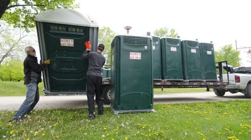 David Lipnowski / Winnipeg Free Press (May 30, 2011) King's Septic & Portable Toilet Service Inc. director of operations Gerry Girardin (left) and employee Joel Ridgeway unload porta-potties at The Forks Monday afternoon in preparations for an NHL announcement and celebration.