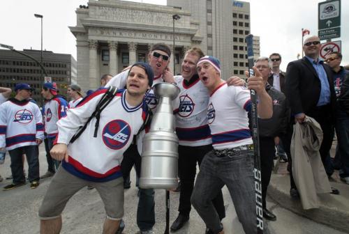 MIKE.DEAL@FREEPRESS.MB.CA 110531 - Tuesday, May 31, 2011 -  Steve Kaltchev (left with cup) and his friends gathered at Portage and Main to celebrate the return of the NHL to Winnipeg, MB. MIKE DEAL / WINNIPEG FREE PRESS