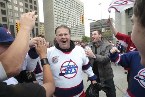 MIKE.DEAL@FREEPRESS.MB.CA 110531 - Tuesday, May 31, 2011 -  Hockey fans gathered at Portage and Main to celebrate the return of the NHL to Winnipeg, MB. Fans cheer as Dancing Gabe arrives at Portage and Main. MIKE DEAL / WINNIPEG FREE PRESS