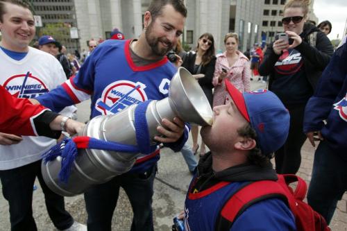 BORIS.MINKEVICH@FREEPRESS.MB.CA   BORIS MINKEVICH / WINNIPEG FREE PRESS 110531 Beer chugging happy NHL fans toast at Portage and Main to the news of an NHL team coming to Winnipeg.