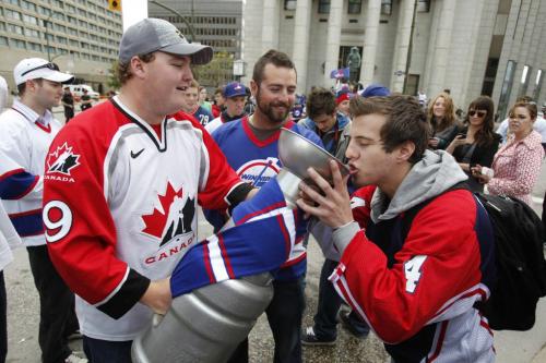 BORIS.MINKEVICH@FREEPRESS.MB.CA   BORIS MINKEVICH / WINNIPEG FREE PRESS 110531 Beer chugging happy NHL fans toast at Portage and Main to the news of an NHL team coming to Winnipeg.