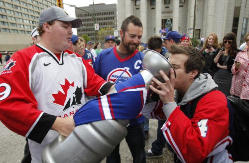 BORIS.MINKEVICH@FREEPRESS.MB.CA   BORIS MINKEVICH / WINNIPEG FREE PRESS 110531 Beer chugging happy NHL fans toast at Portage and Main to the news of an NHL team coming to Winnipeg.