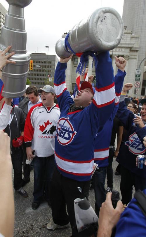 BORIS.MINKEVICH@FREEPRESS.MB.CA   BORIS MINKEVICH / WINNIPEG FREE PRESS 110531 Beer chugging happy NHL fans toast at Portage and Main to the news of an NHL team coming to Winnipeg.