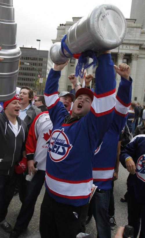 BORIS.MINKEVICH@FREEPRESS.MB.CA   BORIS MINKEVICH / WINNIPEG FREE PRESS 110531 Beer chugging happy NHL fans toast at Portage and Main to the news of an NHL team coming to Winnipeg.