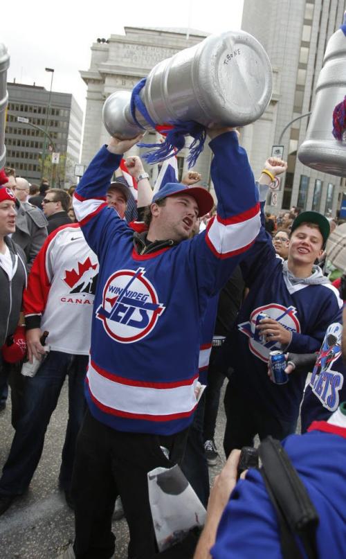 BORIS.MINKEVICH@FREEPRESS.MB.CA   BORIS MINKEVICH / WINNIPEG FREE PRESS 110531 Beer chugging happy NHL fans toast at Portage and Main to the news of an NHL team coming to Winnipeg.