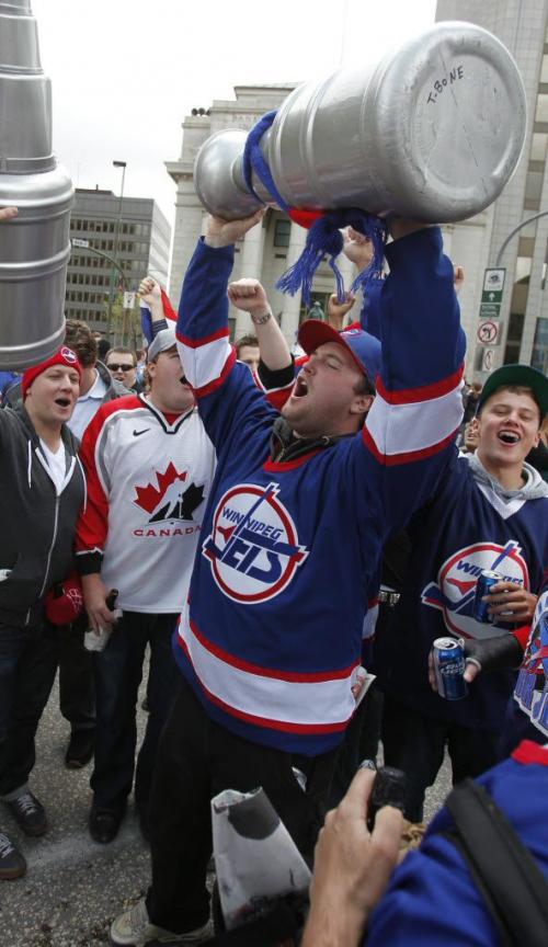 BORIS.MINKEVICH@FREEPRESS.MB.CA   BORIS MINKEVICH / WINNIPEG FREE PRESS 110531 Beer chugging happy NHL fans toast at Portage and Main to the news of an NHL team coming to Winnipeg.