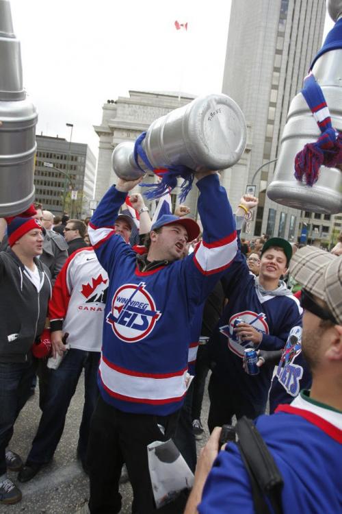 BORIS.MINKEVICH@FREEPRESS.MB.CA   BORIS MINKEVICH / WINNIPEG FREE PRESS 110531 Beer chugging happy NHL fans toast at Portage and Main to the news of an NHL team coming to Winnipeg.