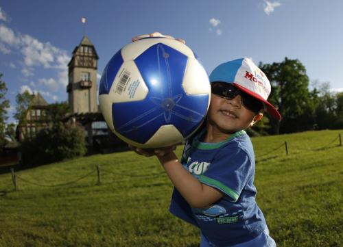 TREVOR HAGAN / WINNIPEG FREE PRESS - Melwin Agravante, 3, steals the ball from his brothers, Meldar, 10, and Meldrick, 13, not shown, in Assiniboine Park. 11-06-03