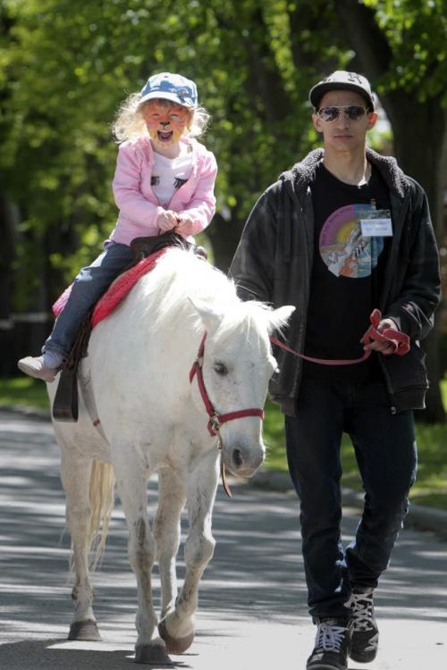 MIKE.DEAL@FREEPRESS.MB.CA 110604 - Saturday, June 04, 2011 -  Abby Aikman, 4, rides Cloudy the pony while volunteer Justin Langton leads the way during the Academy Street Festival Saturday afternoon. MIKE DEAL / WINNIPEG FREE PRESS