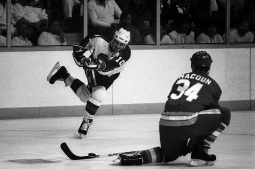 Winnipeg Free Press / Wayne Glowacki / April 11 1987 - Dale Hawerchuk takes shot past Calgary's  Jamie MacCoun in play off action Photo Book Project - Wpg Winnipeg Jets Hockey Club - NHL National Hockey League return -  ( kgjets brings up all Wpg Jets recovered photos in Merlin new book project pics will have slug newjets  for archive pics put in after june 7 2011 )  photos cannot be  published without written permission from the Winnipeg Free Press and credit must include  the Winnipeg Free Press and photographer with each photo