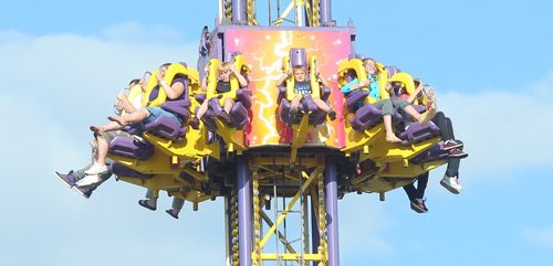 Brandon Sun Riders  grip their shoulder restrains as they fall earthbound on the Mega Drop ride in the midway at the Manitoba Summer Fair on Friday evening. (Bruce Bumstead/Brandon Sun)