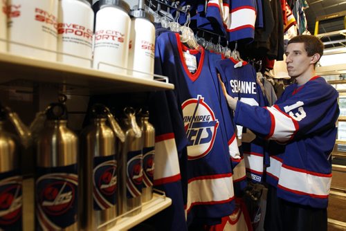 TREVOR HAGAN / WINNIPEG FREE PRESS - Nick Tkachyk, organizing jerseys at River City Sports on Henderson Highway. Jets merchandise has been a hot commodity since True North announced the return of NHL hockey to the city. 11-06-15