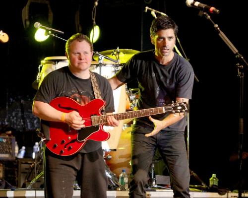 Photo by Ray Peters Darren Enns of Winkler (left) with Beach Boys John Stamos on stage during concert in Winkler Manitoba.  Winnipeg Free Press