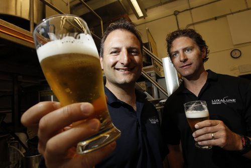 TREVOR HAGAN / WINNIPEG FREE PRESS - Chris and Lawrence Warwaruk, Owners of Luxalune Gastropub, at the Canadian Malting Barley Technical Centre on Main Street. They are both holding a pint of Traditional Ale. 11-06-20