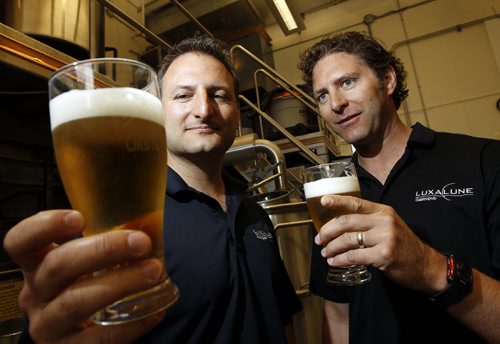 TREVOR HAGAN / WINNIPEG FREE PRESS - Chris and Lawrence Warwaruk, Owners of Luxalune Gastropub, at the Canadian Malting Barley Technical Centre on Main Street. They are both holding a pint of Traditional Ale. 11-06-20