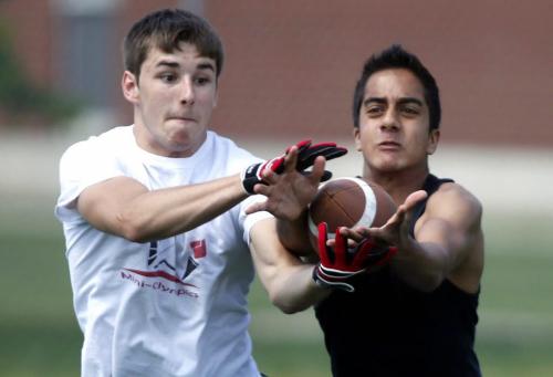 BORIS.MINKEVICH@FREEPRESS.MB.CA   BORIS MINKEVICH / WINNIPEG FREE PRESS 110623 Sisler Highschool Spartins football practice up for the first annual WHFL passing tournament. Karl Sanderson and Jugmeet Brar fight for the ball during practice.