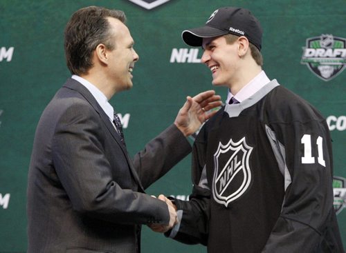 General manager Kevin Cheveldayoff shakes hands with first round pick Mark Scheifele (R) at the 2011 NHL hockey draft in St. Paul, Minnesota,  June 24, 2011. REUTERS/Eric Miller (UNITED STATES - Tags: SPORT ICE HOCKEY)