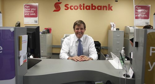 BORIS.MINKEVICH@FREEPRESS.MB.CA   BORIS MINKEVICH / WINNIPEG FREE PRESS 110629 Scotiabank President and CEO Rick Waugh visits his old bank in Windsor Park where. He took pride in standing in his old teller stall.
