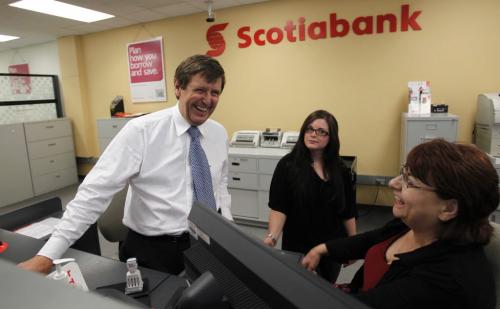 BORIS.MINKEVICH@FREEPRESS.MB.CA   BORIS MINKEVICH / WINNIPEG FREE PRESS 110629 Scotiabank President and CEO Rick Waugh visits his old bank in Windsor Park where. Here he chats with some bank tellers. He took pride in standing in his old teller stall.
